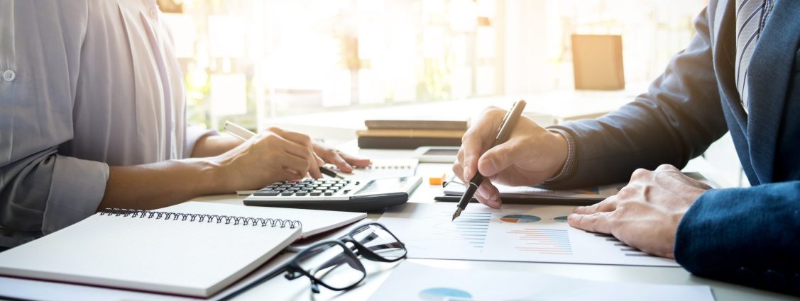 business man financial inspector and secretary making report, calculating or checking balance. Internal Revenue Service inspector checking document. Audit concept